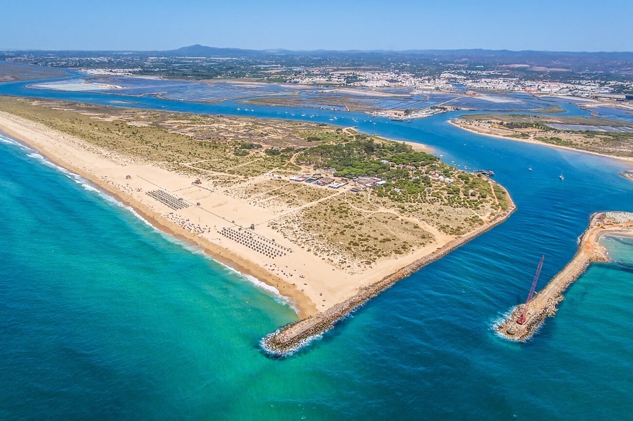Scenic boat ferry route and landing pier connecting the mainland to the sands of Praia de Tavira