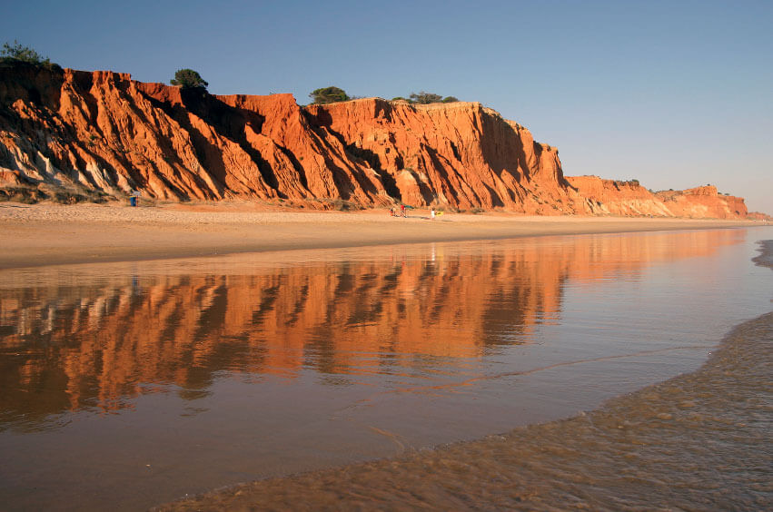 Stunning orange and red sandstone cliffs backing the golden sandy stretch of Praia da Falésia beach near Vilamoura